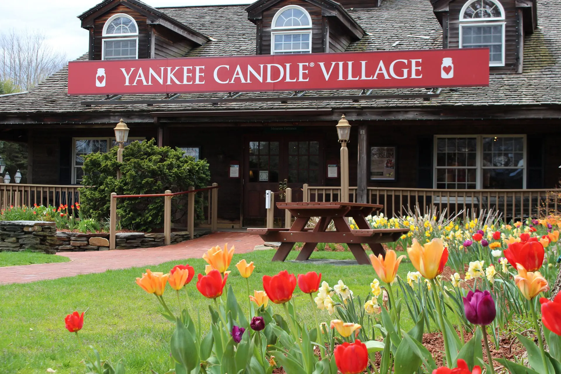 Exterior of Yankee Candle Village with tulips in bloom